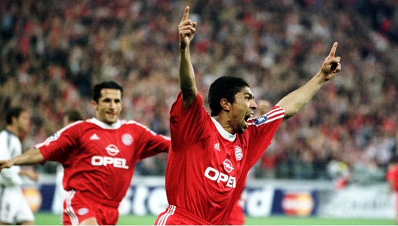 Cái tên đầu tiên là Giovane Elber. Chân sút huyền thoại của Bayern Munich đầu quân cho nhà ĐKVĐ Bundesliga vào giai đoạn 1997-2003. Trong 6 năm thi đấu cho gã khổng lồ xứ Bavaria, tiền đạo người Brazil ghi 133 bàn thắng trong 260 trận. Thành tích này giúp ông trở thành cầu thủ ngoại quốc có số bàn thắng nhiều thứ 3 tại Bundesliga, sau Robert Lewandowski và Claudio Pizarro.
